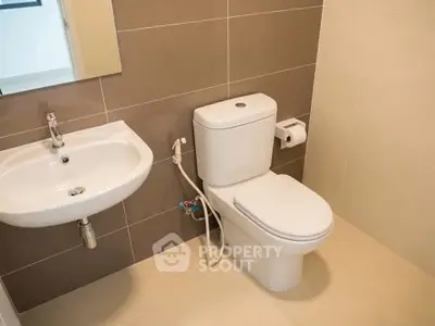 Modern bathroom with sleek fixtures and neutral tiles, perfect for a contemporary home.