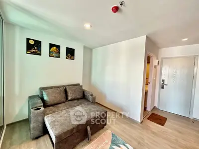 Modern living room with stylish gray sofa and wall art in a cozy apartment