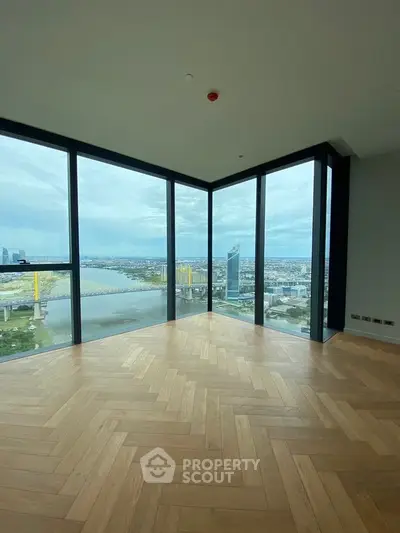 Stunning corner unit with panoramic city and river views, featuring elegant herringbone flooring.