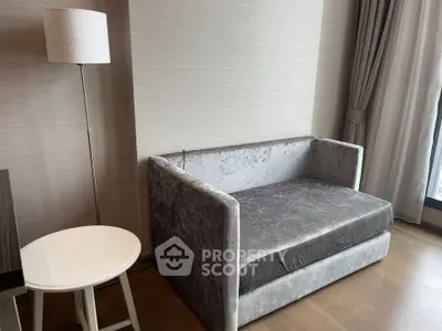 Modern living room with stylish gray sofa and elegant floor lamp