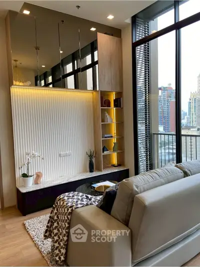 Modern living room with stylish decor and city view from large windows.