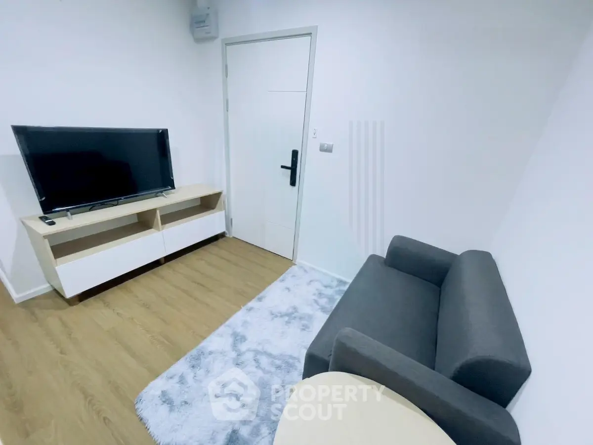 Modern living room with sleek TV setup and cozy seating area