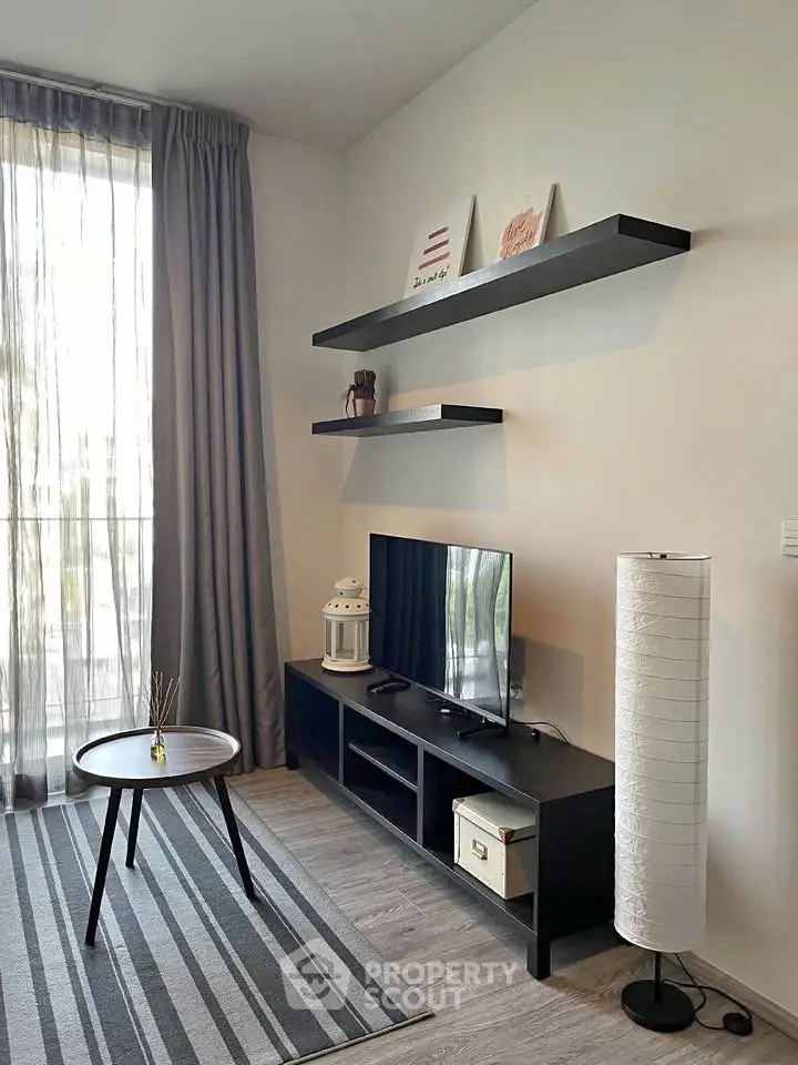 Modern living room with stylish decor, featuring a sleek TV stand, floating shelves, and a cozy ambiance.