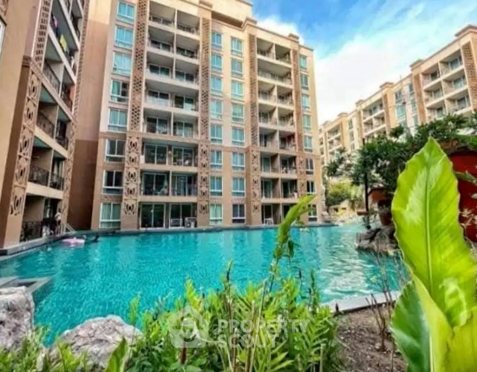 Luxurious apartment complex with stunning pool and modern architecture.