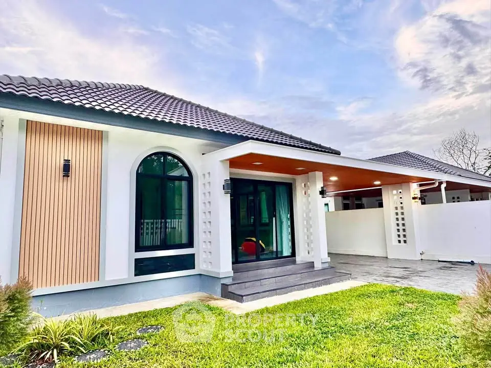 Charming modern house with elegant exterior design and lush green lawn, perfect for family living.