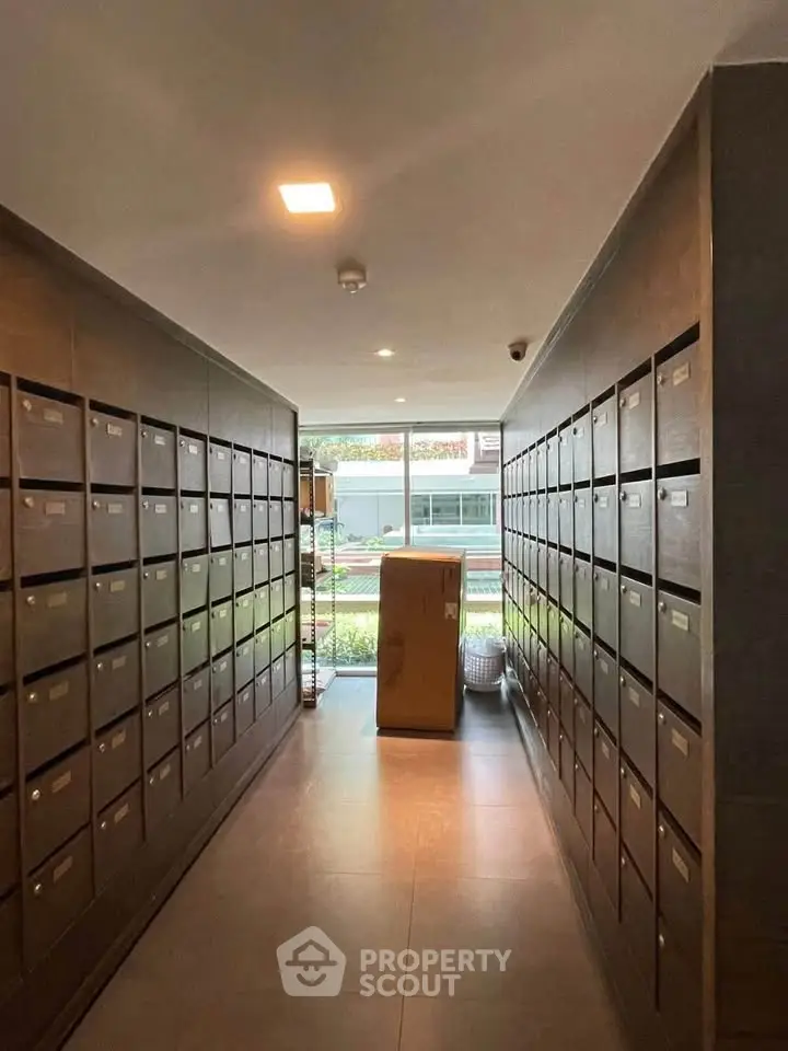 Modern apartment building mailroom with sleek design and natural light.