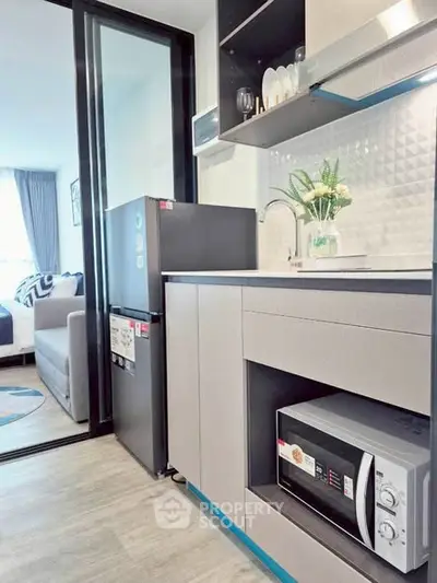Modern kitchen with sleek appliances and open layout in stylish apartment