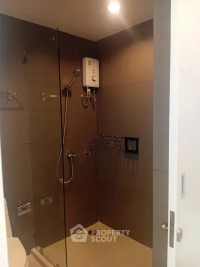 Modern bathroom with glass shower enclosure and water heater