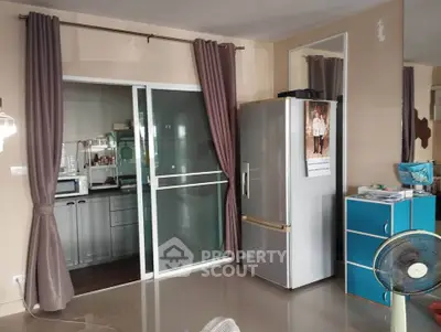 Modern kitchen with sliding glass door and stainless steel fridge