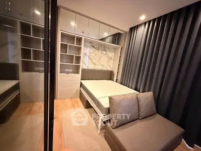 Modern bedroom with stylish decor and ample storage in a contemporary apartment.