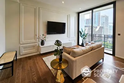 Elegant living room with herringbone wood flooring, white panel walls, and a large window leading to a balcony with city views.