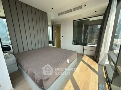 Luxurious bedroom with floor-to-ceiling windows and city view, featuring modern design and ample natural light.