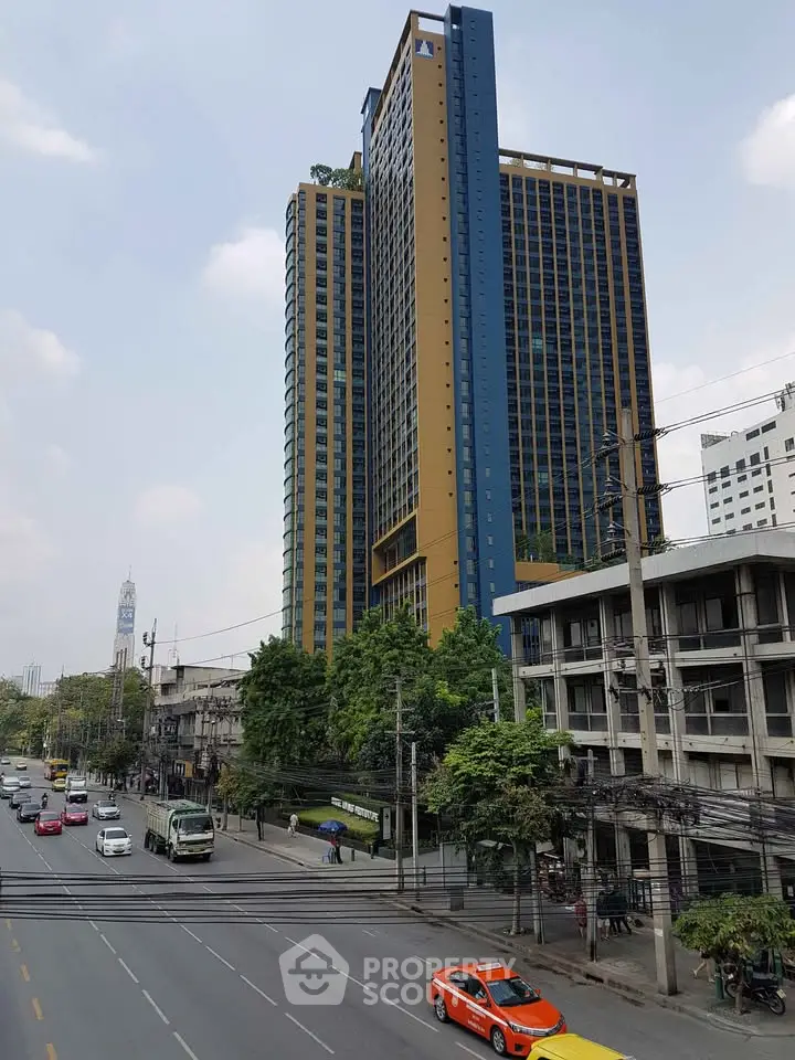 Modern high-rise building with urban street view and vibrant cityscape.