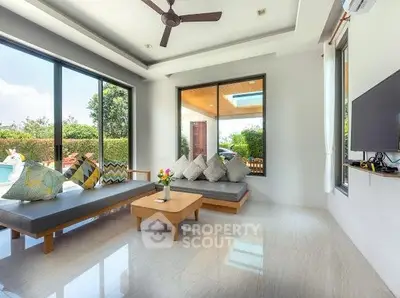 Spacious modern living room with pool view and stylish decor