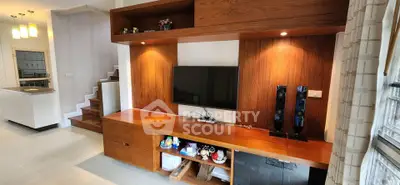 Modern living room with built-in wooden entertainment center and sleek design