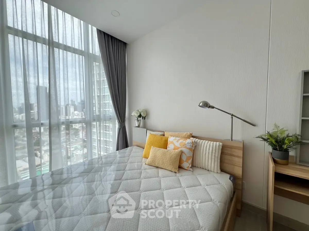 Modern bedroom with large windows and stylish decor in urban apartment