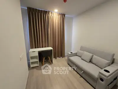 Modern living room with sleek sofa and study desk, featuring elegant curtains and minimalist design.