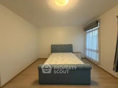 Spacious bedroom with elegant bed and natural light