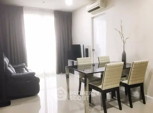 Modern living room with sleek dining area and cozy seating
