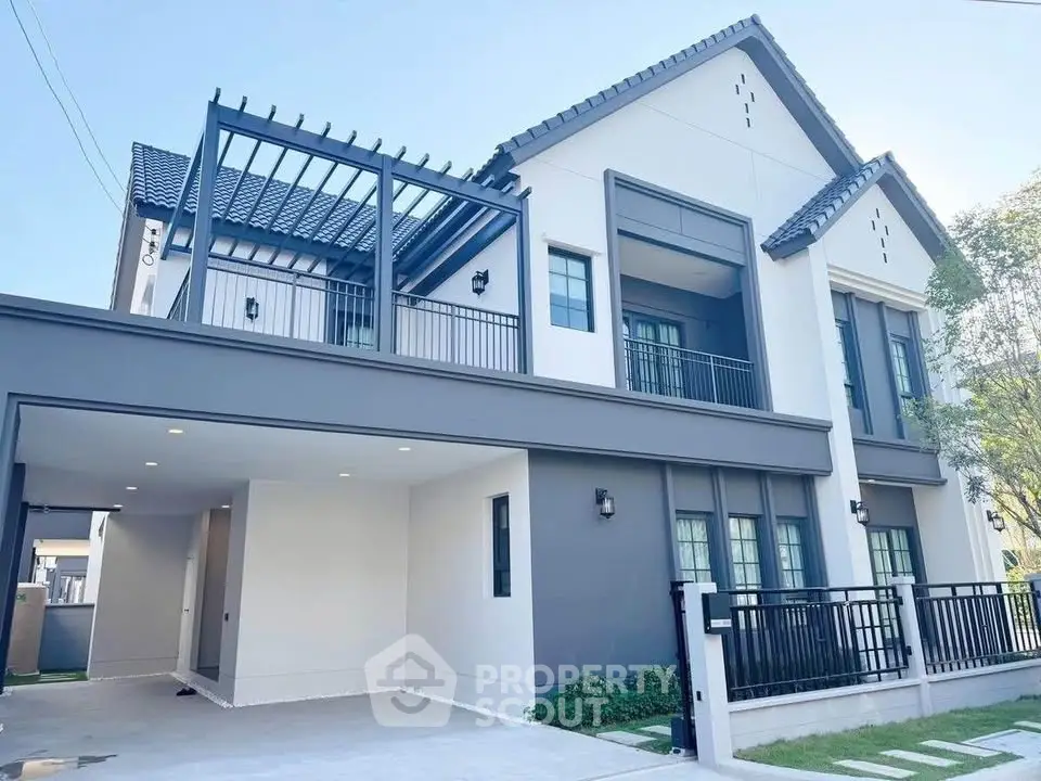 Modern two-story house with sleek design and spacious driveway, featuring large windows and a stylish pergola.