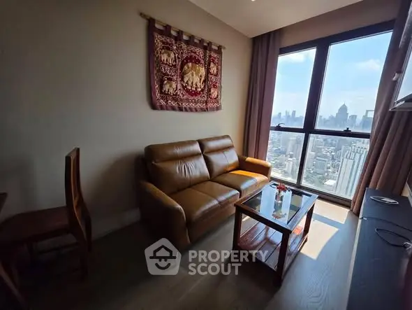 Stylish living room with leather sofa and stunning city view from large windows.