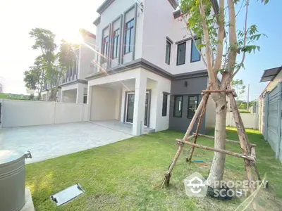 Modern townhouse exterior with spacious garden and driveway