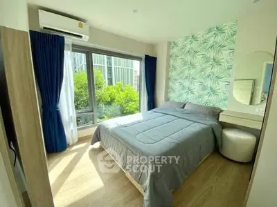 Bright and cozy bedroom with large window and modern decor