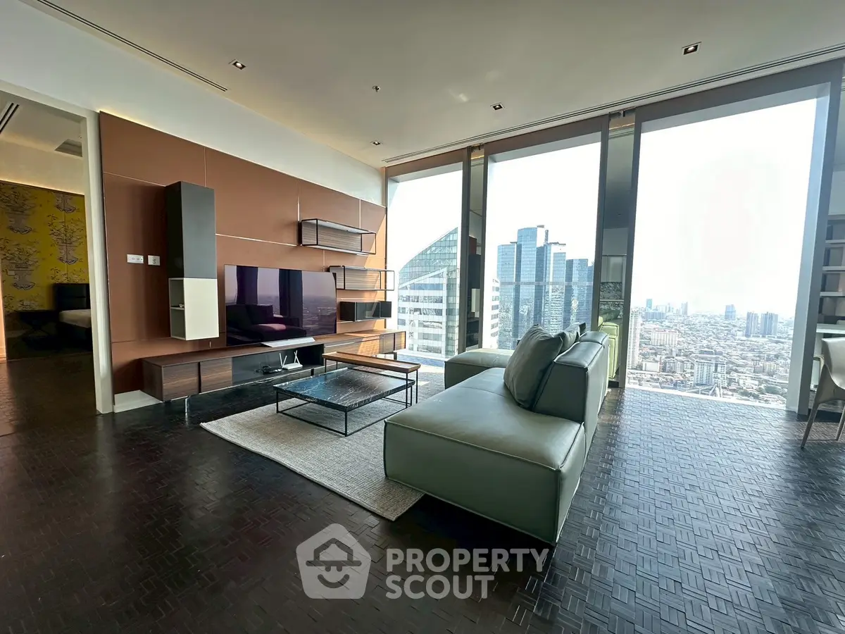 Luxurious living room with stunning city view and modern furnishings in high-rise apartment.