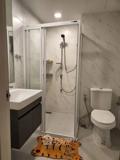 Modern bathroom with shower cabin and stylish fixtures in a contemporary apartment.