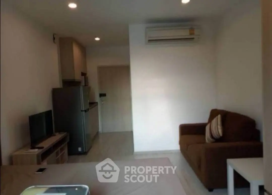 Cozy living room with modern furniture and air conditioning in a compact apartment.