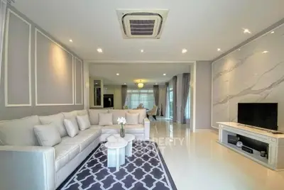 Spacious modern living room with elegant decor and cozy seating area, perfect for relaxation and entertainment.