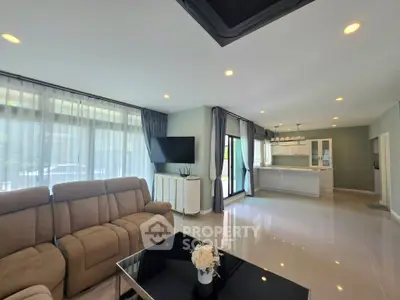 Spacious modern living room with open kitchen and large windows