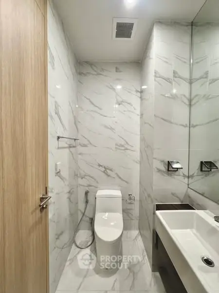 Modern bathroom with marble tiles and sleek fixtures