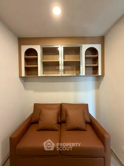 Cozy living room with modern brown sofa and stylish wall shelves