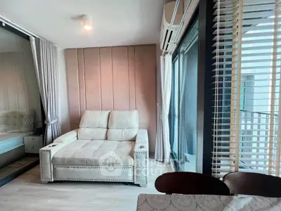 Modern living room with stylish sofa and large windows in a contemporary apartment.