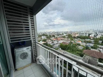 Stunning high-rise balcony with panoramic city views and protective netting, perfect for urban living.