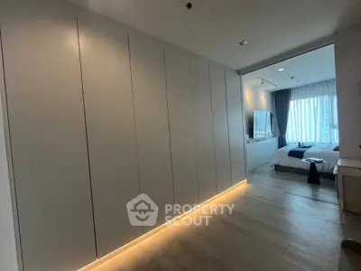 Modern bedroom with sleek built-in wardrobe and ambient lighting