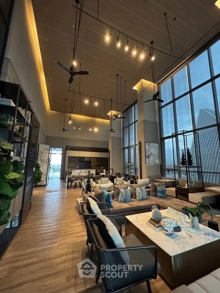 Luxurious high-ceiling living room with modern decor and panoramic city views.