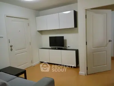 Modern living room with sleek white cabinets and flat-screen TV