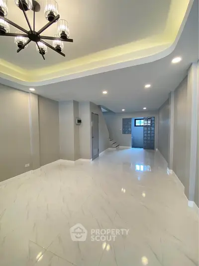 Spacious modern living room with elegant lighting and marble flooring