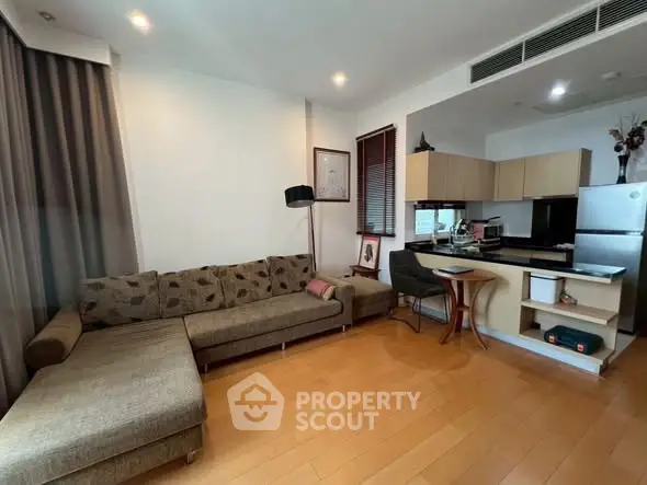 Modern living room with open kitchen and stylish decor in a cozy apartment.