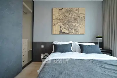 Modern bedroom with stylish decor and map artwork, featuring a cozy bed and elegant design.