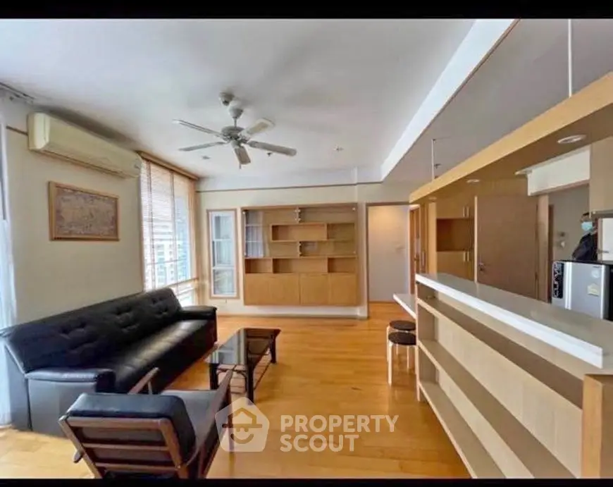 Spacious living room with modern furniture and open kitchen layout