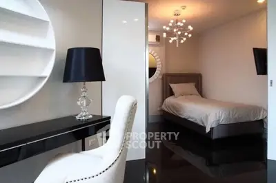 Modern bedroom with sleek black flooring and elegant lighting