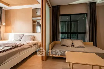 Modern bedroom with cozy seating area and stylish decor