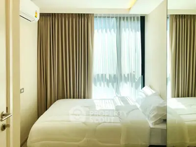 Bright and cozy bedroom with large window and modern decor