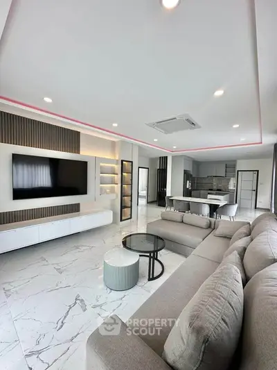 Spacious modern living room with open kitchen and sleek design