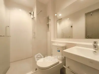 Modern bathroom with sleek fixtures and spacious shower area