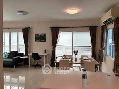 Spacious living room with dining area and natural light in modern apartment
