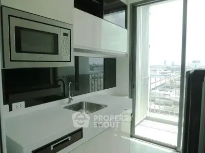 Modern kitchen with sleek design and balcony view in urban apartment